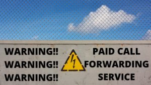 Brick wall with caution sign to warn about paid call forwarding service